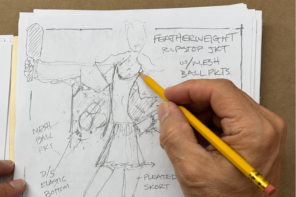 hand sketches a fashion design for the beginning of a fashion line/new brand