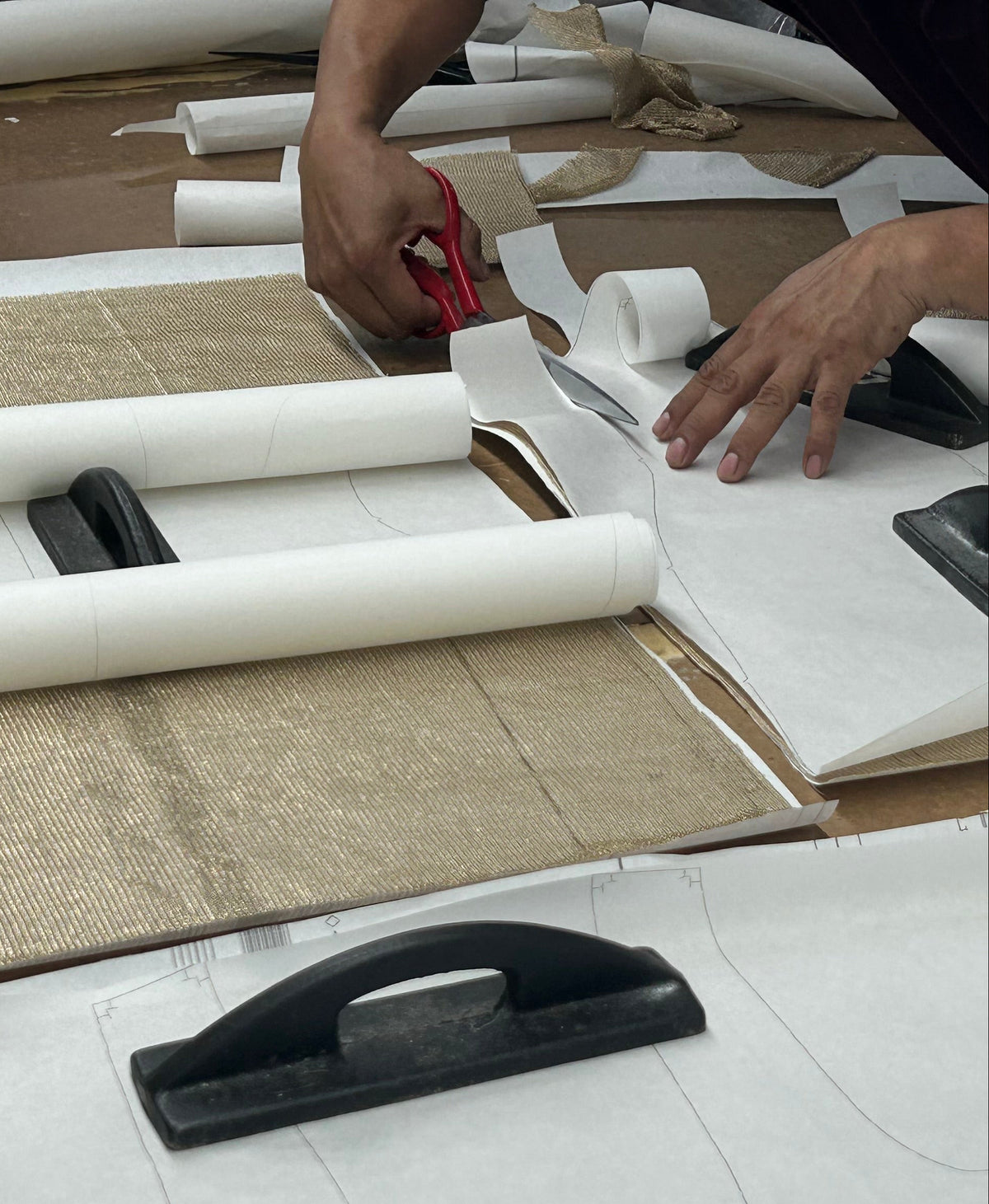 cutting a pattern for a sample on a cutting table in a factory 