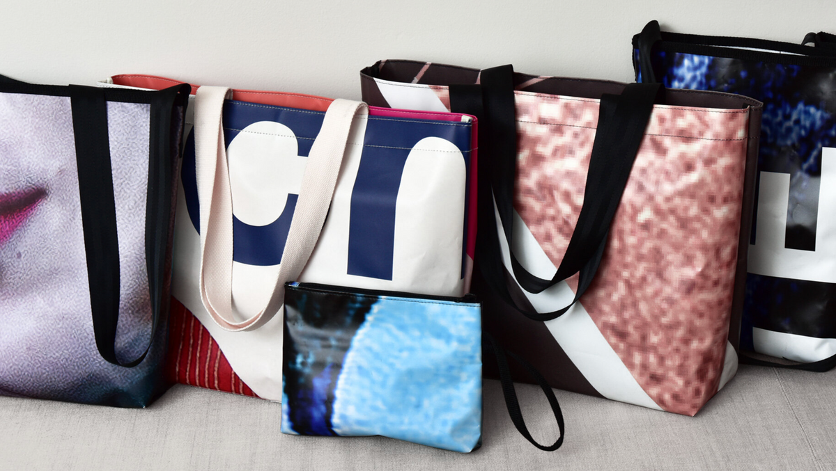 Product image of a collection of various THROW bags made of recycled vinyl banners